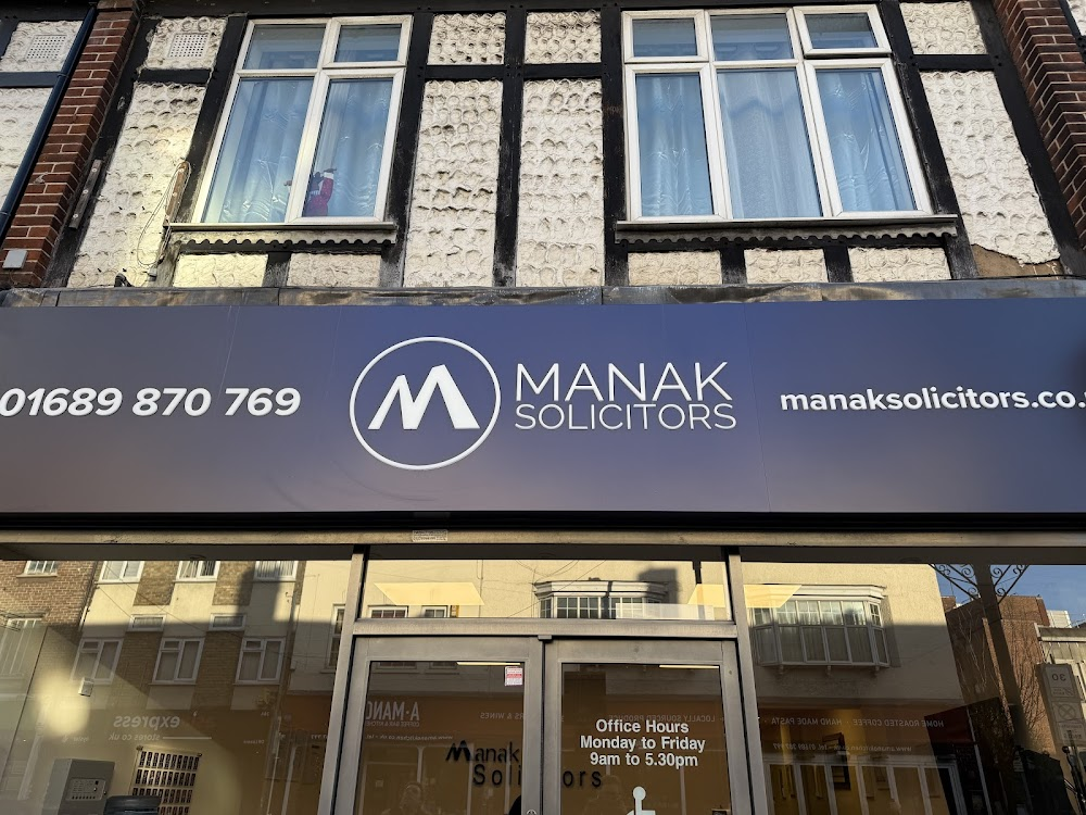 Exterior of the Manak Solicitors office in Orpington showing the firm's signage and telephone number.
